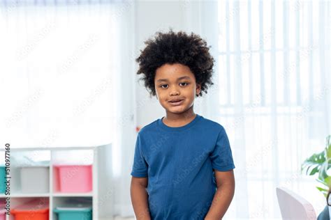 Portrait of African boy student stand with happiness in class room. Stock Photo | Adobe Stock