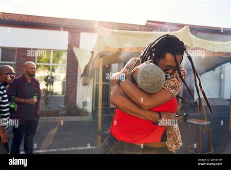 Happy Friends Hugging In Sunny Parking Lot Stock Photo Alamy