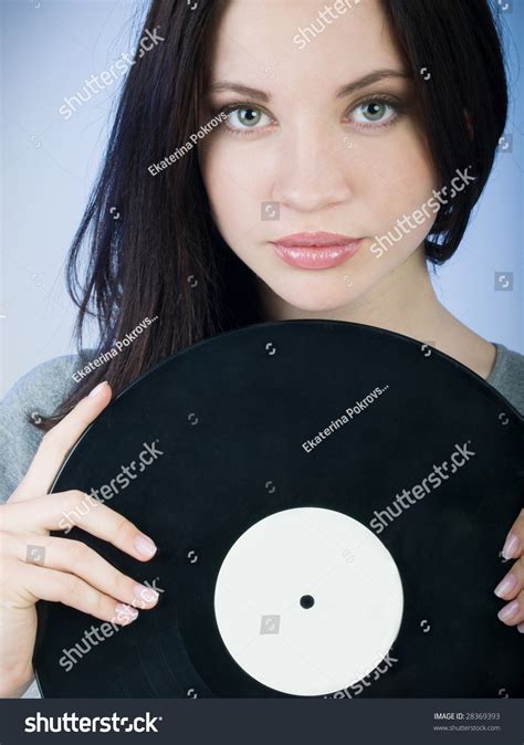 Beautiful Girl Holding A Vinyl Record In Front Of Her Stock Photo