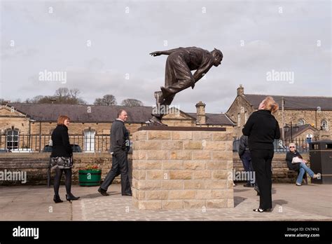 People Standing Looking Walking By Bronze Statue Of Cricketer Fred