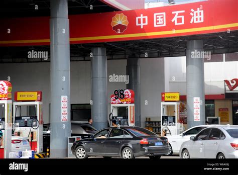 FILE Chinese Drivers Line Up Their Cars To Be Refuelled At A Gas