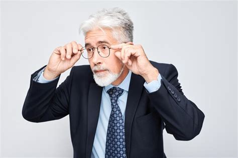 Premium Photo Confident Senior Businessman Adjusting Glasses Isolated