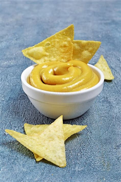 Mexican Nachos Chips With Cheese Sauce Or Dip In White Bowl Stock Photo