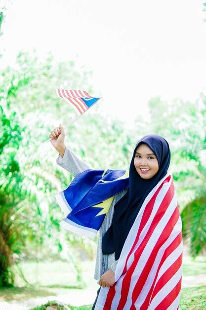 Premium Photo Muslim Woman Happy Holding A Malaysian Flag Malaysia