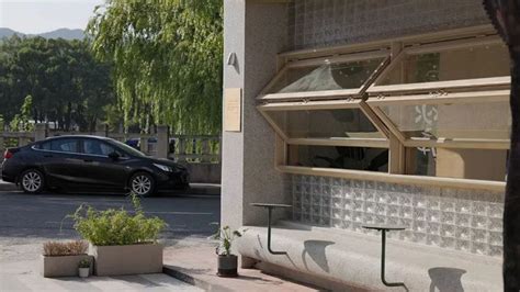 A Car Is Parked In Front Of A Building