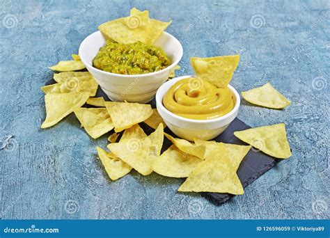 Mexican Nachos Chips With Green Guacamole And Cheese Sauce Or Dip In