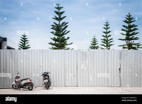 A corrugated metal wall erected in-front of the beach along Walking ...