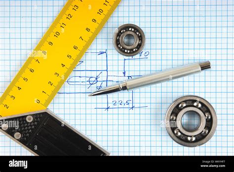 Calipers Bearing And Square On The Background Of Graph Paper Stock