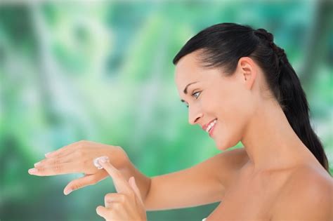 Premium Photo Beautiful Nude Brunette Applying Hand Cream