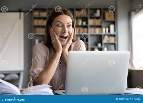 Excited Surprised Woman Looking At Laptop Screen Reading News Stock