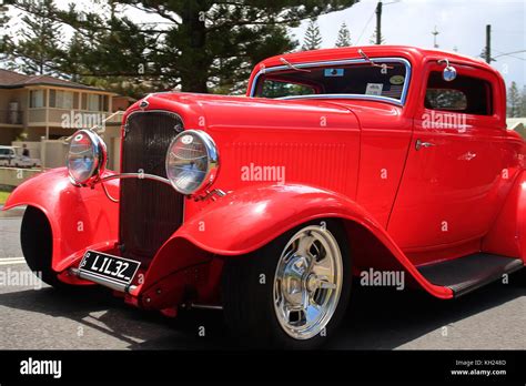 A Bigger Than Life Bright Red Hot Rod Smoothly Rolls Along Yamba Streets In The Annual Hot Rod