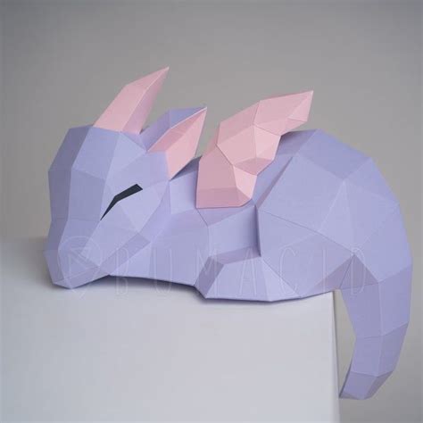 An Origami Paper Sculpture Of A Purple Dragon On A White Pedestal With