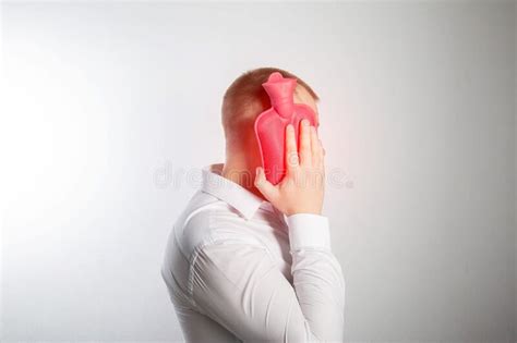 A Man Holds A Heating Pad With Hot Water Near His Cheek Toothache Infection Heat Treatment