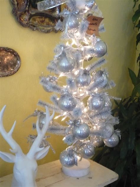 Small White Feather Christmas Tree Sitting On A Vintage Ironing Board