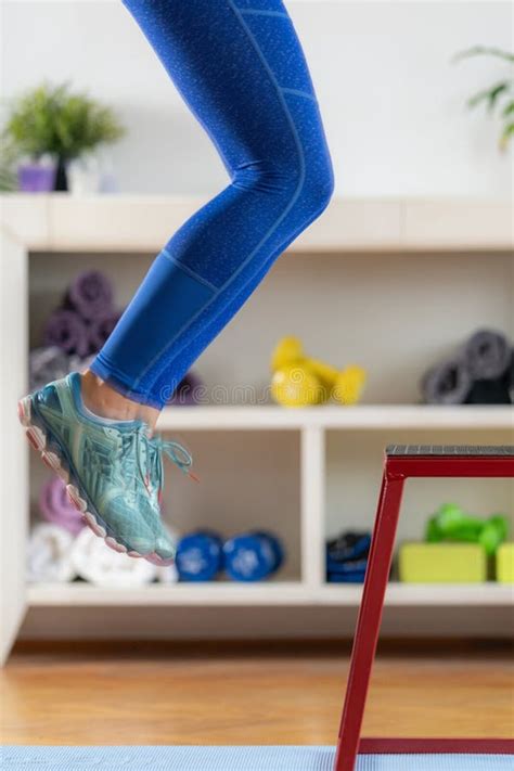 Home Workout Routine A Woman Uses A Stool For Jumping Exercises