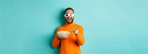 Premium Photo Man Watching Comedy In D Glasses Eating Popcorn