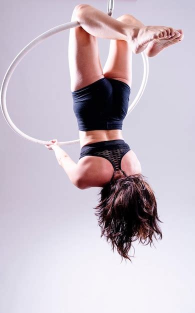 Premium Photo | A female aerial hoop gymnast performing exercises on an aerial hoop