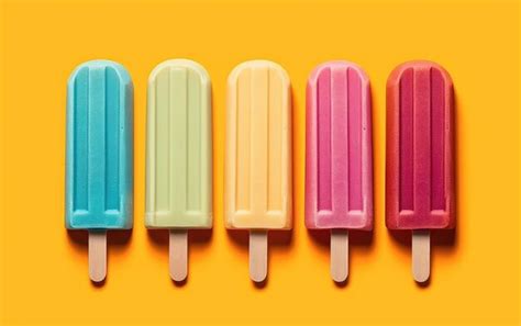 Premium AI Image | A row of colorful popsicle popsicle sticks with a ...