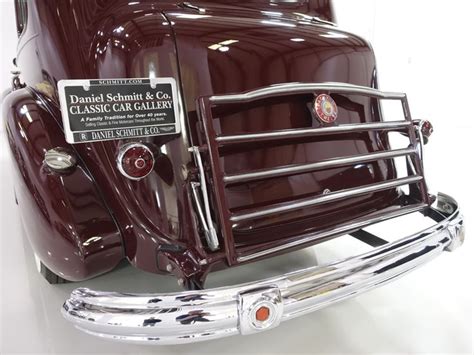 The Front End Of An Antique Car With Chrome Grilles