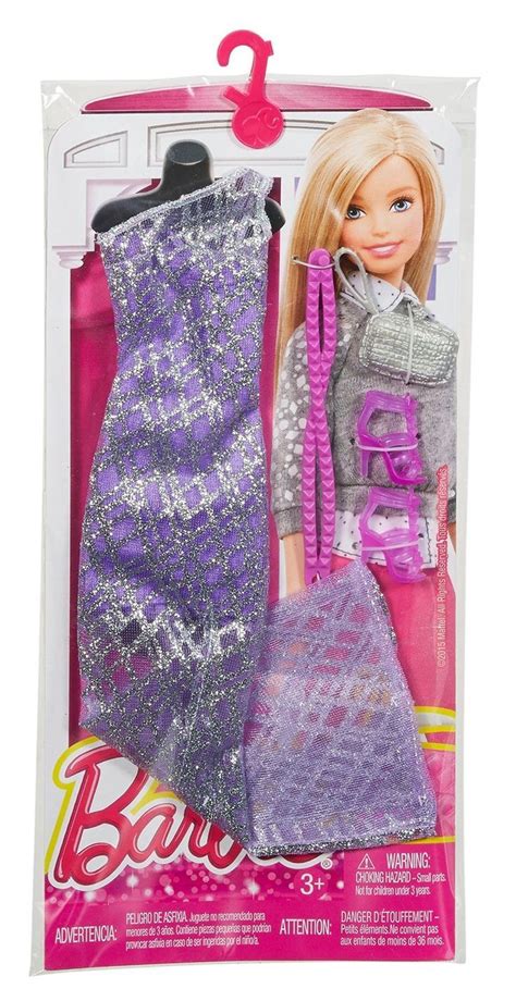 The Barbie Doll Is Wearing A Purple Dress And Holding A Pink Handbag In