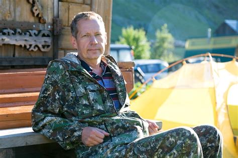 Premium Photo Portrait Of Mature Man Sitting On Bench