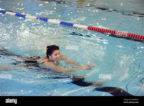 Smiling Mature Woman Swimming In Pool At Weekend Stock Photo Alamy
