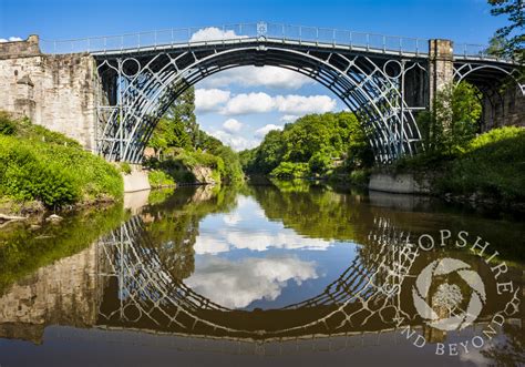 The Iron Bridge Reflected In The River Severn At Ironbridge Shropshire