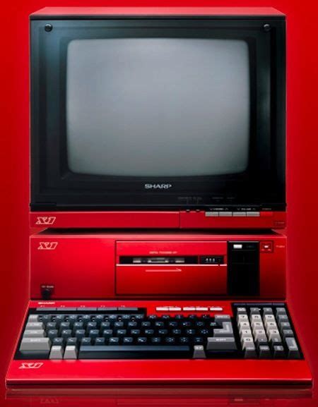 An Old Red Computer With A Keyboard And Monitor On The Top Sitting In