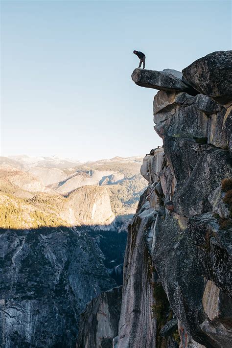 "Young Man Taking Risk Looking Over Edge Of Cliff On High Mountain" by Stocksy Contributor ...