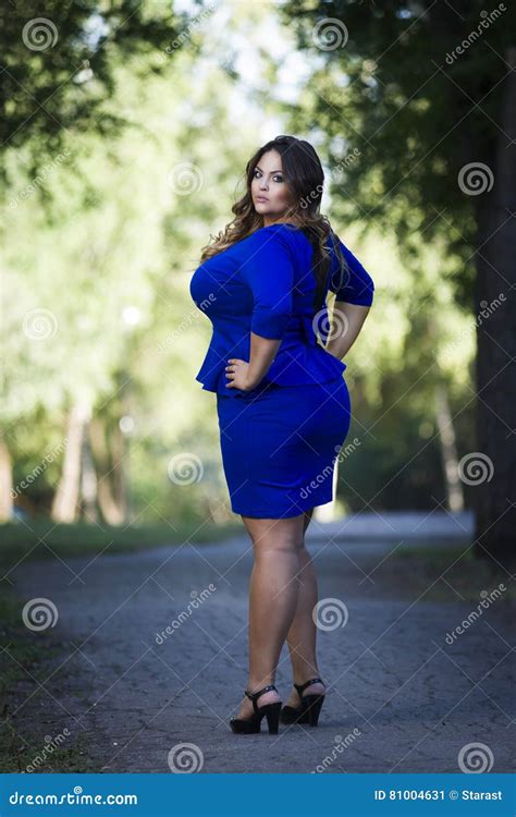 Young Beautiful Stylish Plus Size Fashion Model In Blue Dress Outdoors