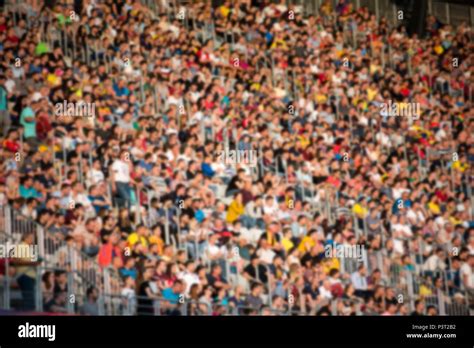 Blurred Crowd Of People Supporters And Fans In A Stadium Tribune At A