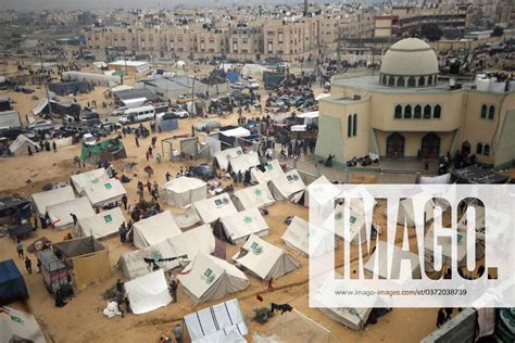 Displaced Palestinians Who Fled From Khan Yunis Sit Outside Makeshift