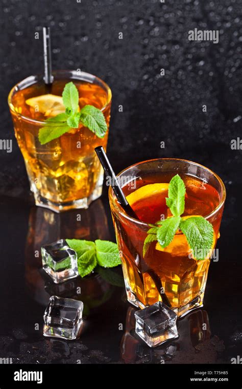 Two Glasses With Cold Traditional Iced Tea With Lemon Mint Leaves And