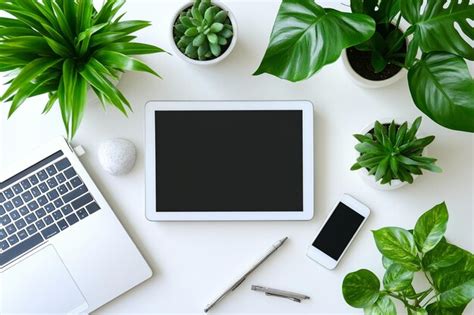 Top View Of A White Office Desk With Electronic Devices And Accessories