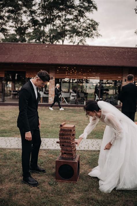 Bride and Groom Playing a Game at the Wedding Reception · Free Stock Photo