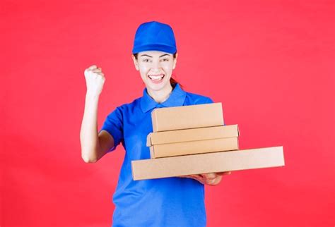 Premium Photo Female Courier In Blue Uniform Holding A Stock Of