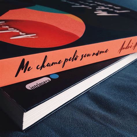 Two Books Sitting Side By Side On Top Of A Blue Cloth Covered