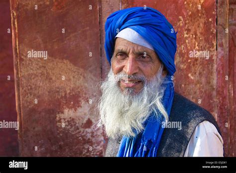 A Muslim Man With A Blue Turban And A White Beard At A Mosque In The