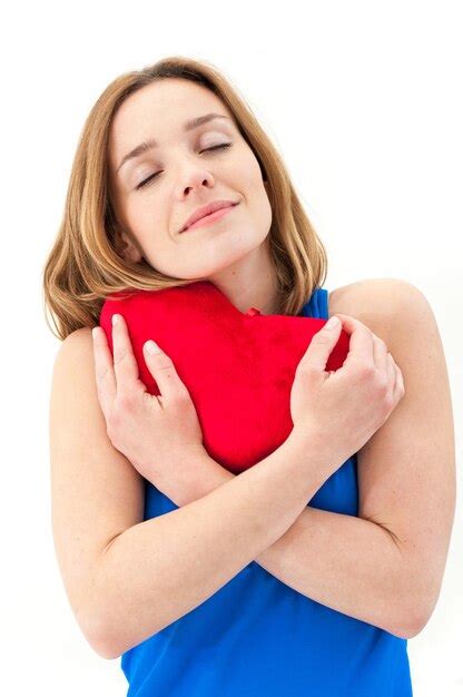 Premium Photo Beautiful Woman With Heart Shape Pillow Against White