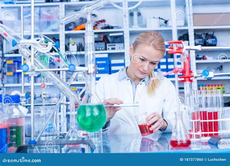 Female Laboratory Assistant With Chemical Experiment In Scientific