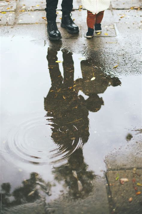 Mother And Daughter Puddle Reflection By Stocksy Contributor Jovana