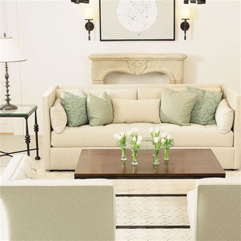 Bernhardt Airy Living Room Cream Sofa With Aqua Pillows Pale Beige Stone Fireplace Mantel