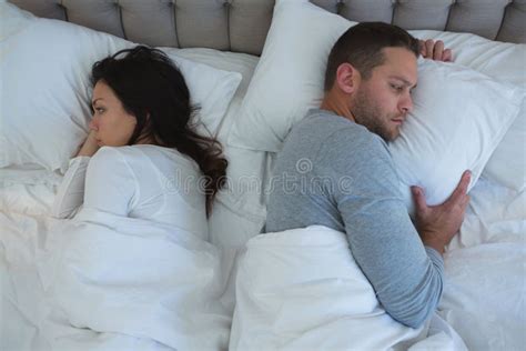 Angry Couple Avoiding Each Other In Bedroom Stock Image Image Of