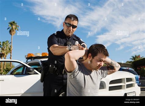 police officer arresting young man stock photo alamy