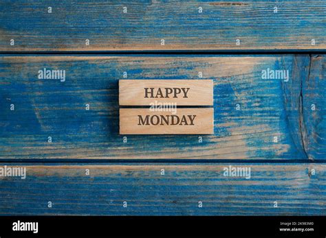 Happy monday sign written on two stacked wooden pegs placed over ...