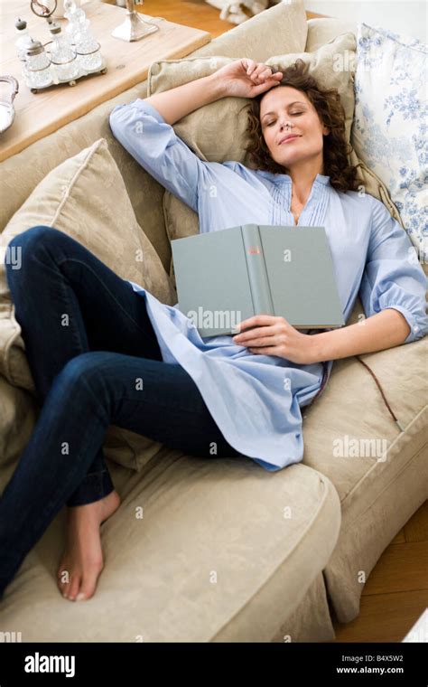 Woman sleeping on a couch Stock Photo - Alamy