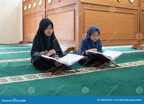 Two kids read holy quran stock image. Image of hijab - 180923453