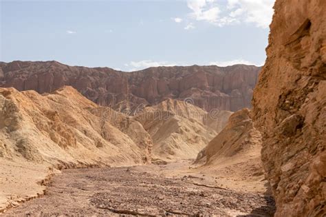 Rear View Of Man Hiking In Golden Canyon With Scenic View Of Colorful