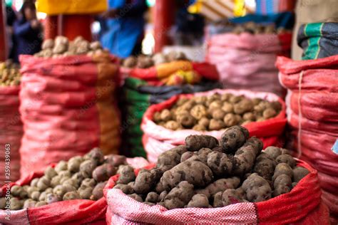 Different types and varieties of Peruvian organic potatoes in sacks at local market in Cusco ...