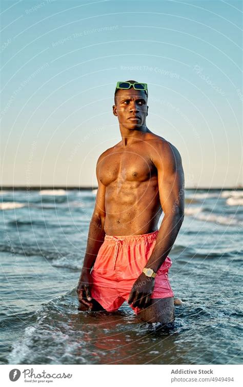 Pensive Shirtless Black Man In Sea Water A Royalty Free Stock Photo